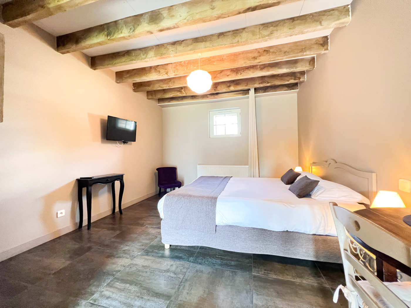 Chambre en rez-de-chaussée du lodge, sous les poutres